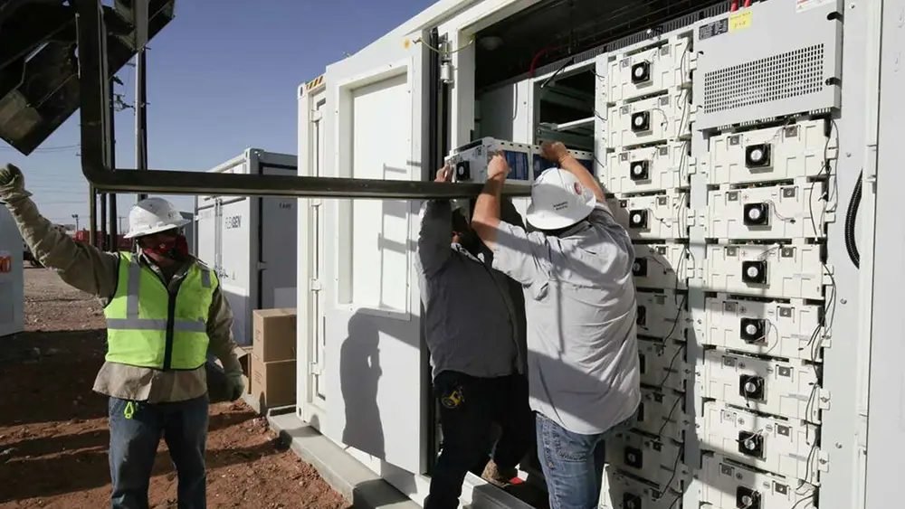 Focus image of electric vehicle recharging battery at home charging station with blurred woman walking in the background. Progressive concept of green energy technology applied in daily lifestyle.